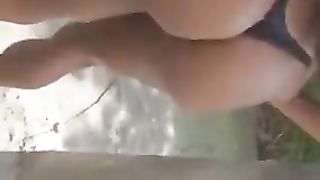 Guy kneading a semi-bare ebony trans chick in public