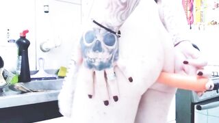 Transgender housewife stuffing a carrot into her rear entrance.