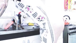 Transgender housewife stuffing a carrot into her rear entrance.